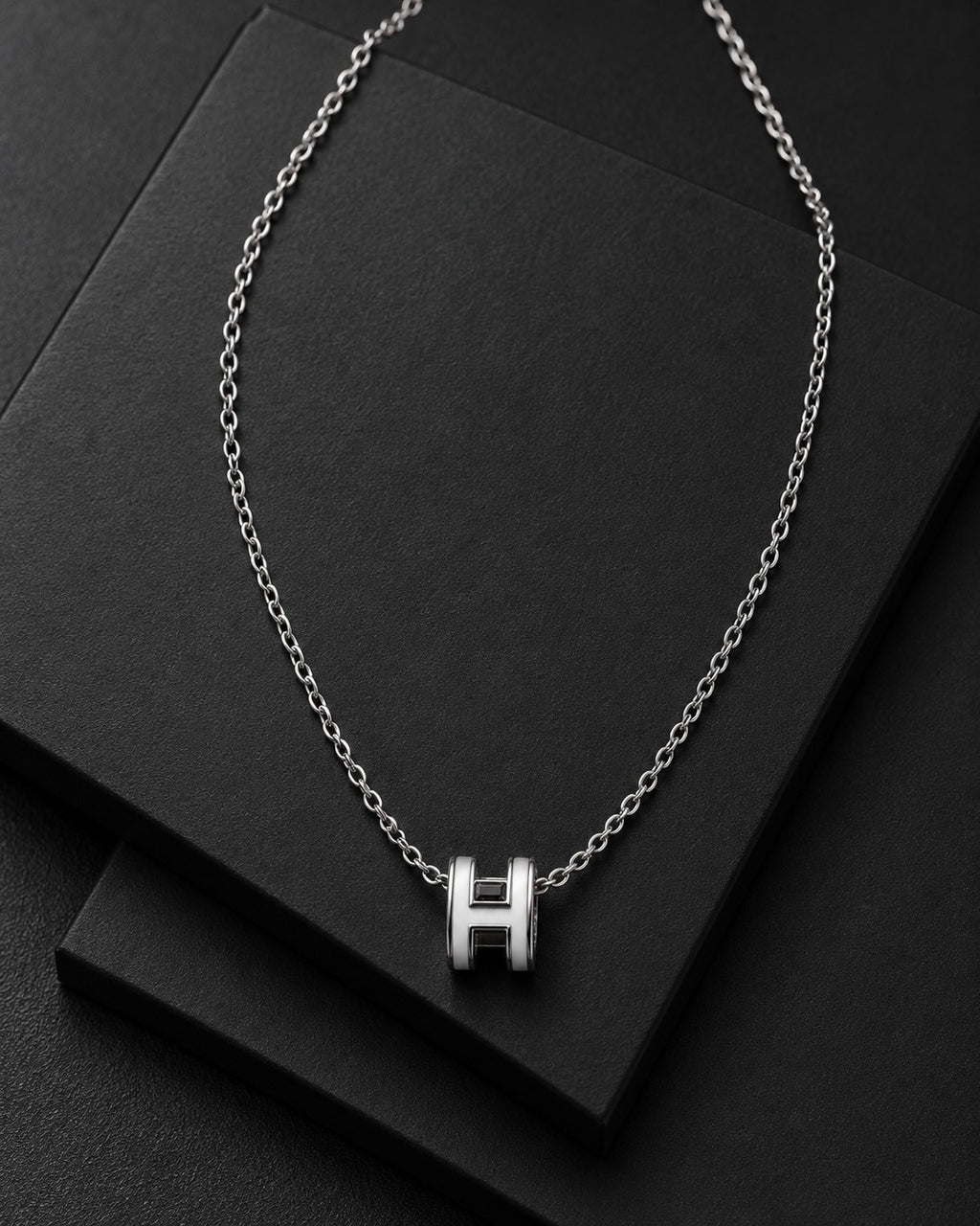 Detail view of the polished H-link pendant necklace