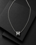 Detail view of the polished H-link pendant necklace