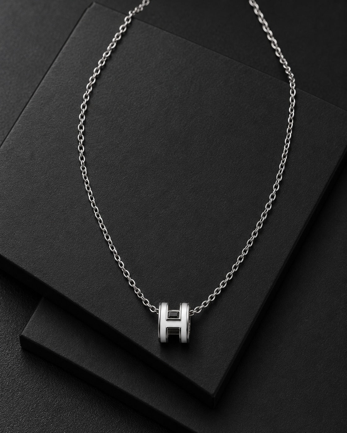 Detail view of the polished H-link pendant necklace